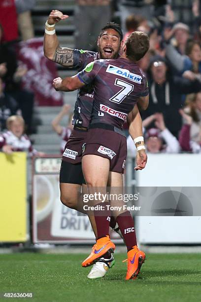 Feleti Mateo and Daly Cherry Evans of the Sea Eagles celebrate a try during the round 21 NRL match between the Manly Sea Eagles and the Brisbane...