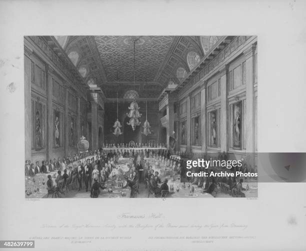 Engraved view of the cavernous interior of Freemason's Hall; during a dinner of the Humane Society, London, circa 1850-1900. Engraved by H Melville...