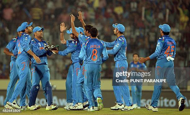 India players celebrate after the wicket of South Africa batsman Quinton de Kock during the ICC World Twenty20 cricket tournament second semi-final...