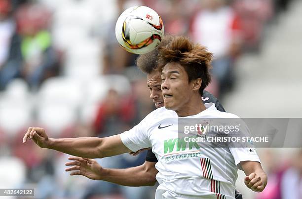 Augsburg's South-Korean defender Jeong-Ho Hong and Toulouse's Danish forward Martin Braithwaite vie for the ball during a friendly football match...