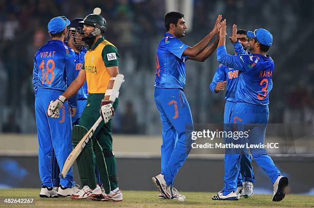 Suresh Raina of India congratulates Ravichandran Ashwin on bowling Hashim Amla of South Africa during the ICC World Twenty20 Bangladesh 2014 Semi...