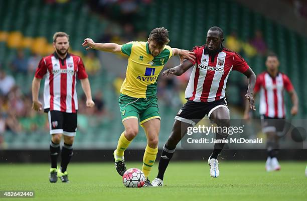 Jonny Howson of Norwich City battles with Toumani Diagouraga of Brentford during the pre season friendly match between Norwich City and Brentford at...