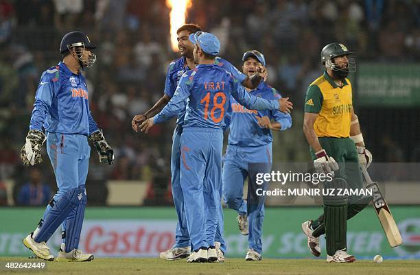 India cricketer Ravichandran Ashwin celebrates with his teamates after the dismissal of South Africa cricketer Hashim Amla during the ICC World...