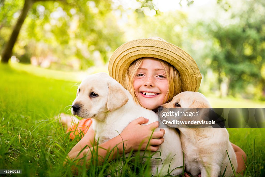 Happy girl hugging puppies