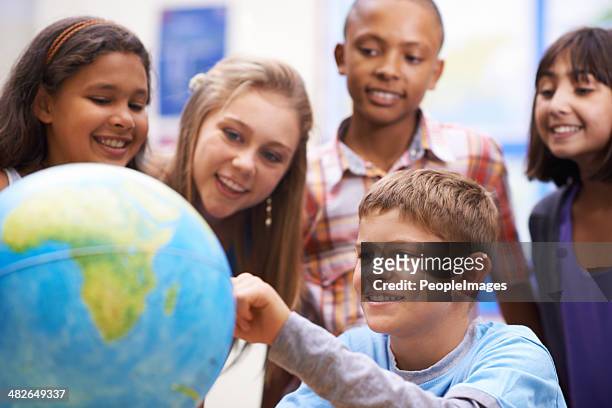 here it is! - geography class - child globe stockfoto's en -beelden