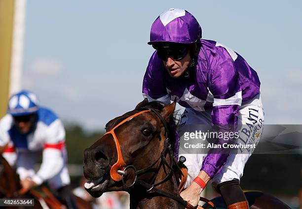 Richard Hughes riding Fox Trotter eases down after finishing unplaced on his last ever ride as a jockey at Goodwood racecourse on August 01, 2015 in...