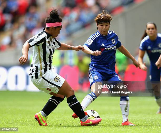 Ji So-Yun of Chelsea, who scored the winning goal, is tackled by Desiree Scott during the Women's FA Cup Final match between Chelsea Ladies FC and...