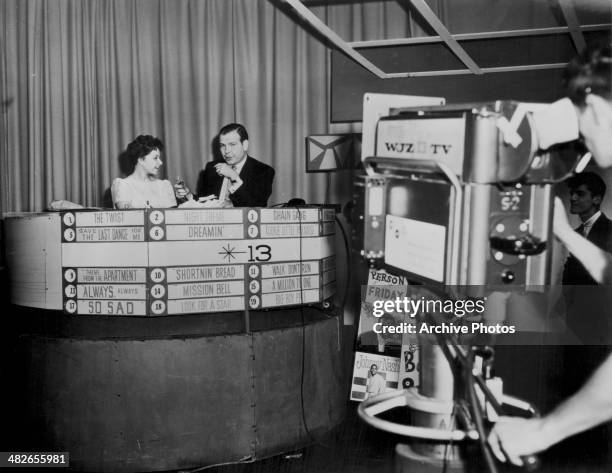 American singer Brenda Lee being interview on a televised chart show, circa 1960.