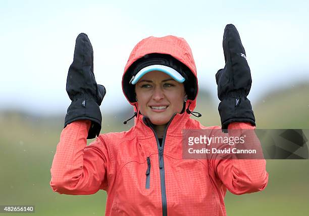 Amy Boulden of Wales sheltering from the elements after she had played her second shot at the par 5, 17th hole during the third round of the 2015...