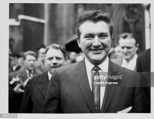 American pianist Liberace smiling as he leaves court, following libel action against the Daily Mail over a slanderous article, London, June 9th 1959.