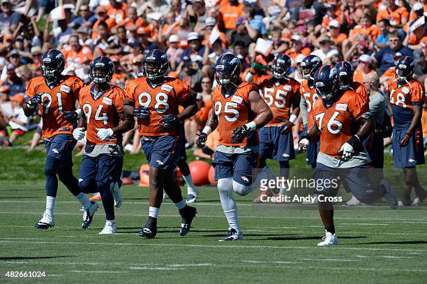 Denver Broncos defensive players from left to right, Kenny Anunike, #91, DeMarcus Ware, #94, Darius Kilgo, #98, Derek Wolfe, #95, and Marvin Austin...