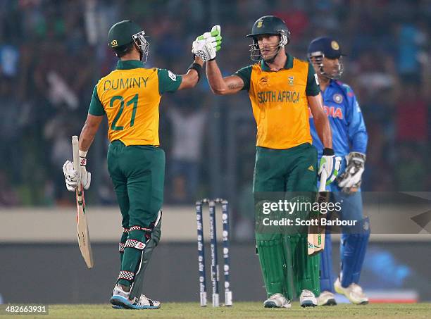 Jean-Paul Duminy congratulates Faf du Plessis of South Africa hits he hit a six as MS Dhoni of India looks on during the ICC World Twenty20...