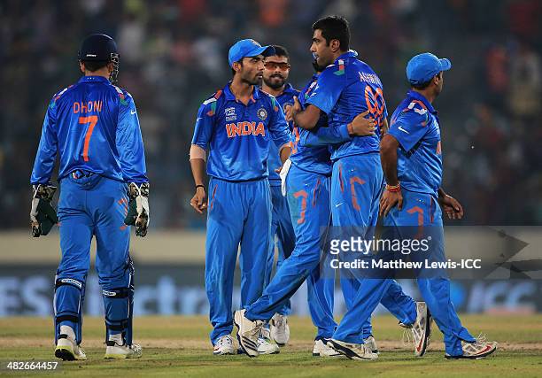 Ravichandran Ashwin of India is congratulated on the wicket of AB de Villiers of South Africa with MS Dhoni during the ICC World Twenty20 Bangladesh...