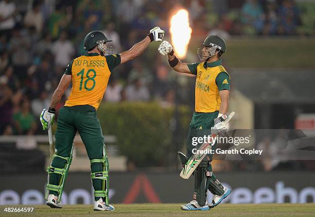 Faf du Plessis and JP Duminy of South Africa punch gloves during the ICC World Twenty20 Bangladesh 2014 semi final between India and South Africa at...
