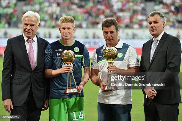 Kevin De Bruyne and head coach Dieter Hecking of VfL Wolfsburg are honored by german sport magazine KICKER prior to kickoff during the DFL Supercup...