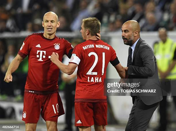 Bayern Munich's Dutch midfielder Arjen Robben looks on as Bayern Munich's Spanish head coach Pep Guardiola talks to Bayern Munich's defender Philipp...