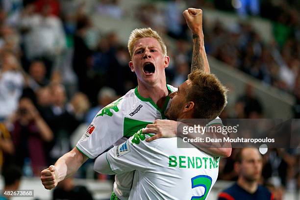 Nicklas Bendtner of VfL Wolfsburg celebrates scoring his teams first goal of the game with team mate Kevin De Bruyne during the DFL Supercup match...