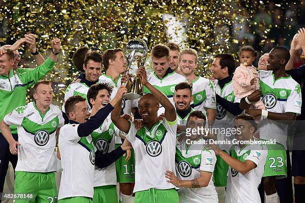 Naldo of VfL Wolfsburg lifts the trophy after the DFL Supercup 2015 match between VfL Wolfsburg and FC Bayern Muenchen at Volkswagen Arena on August...