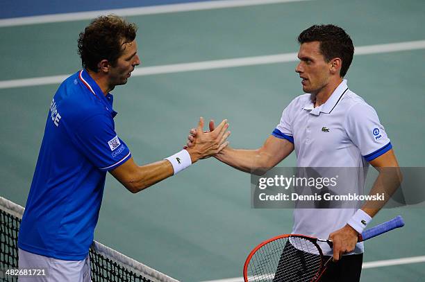 Tobias Kamke of Germany shakes hands with Julien Benneteau of France after winning his match against Julien Benneteau of France during day 1 of the...