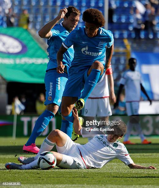 Axel Witsel of FC Zenit St. Petersburg and Artem Dzyuba of FC Zenit St. Petersburg vie for the ball with Daler Kuzyayev of FC Terek Grozny during the...