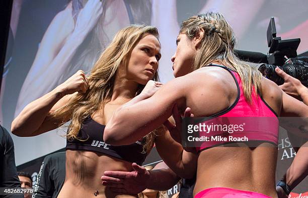 Women's bantamweight champion Ronda Rousey of the United States and Bethe Correrira of Brazil face off during the UFC 190 weigh-in event at the HSBC...