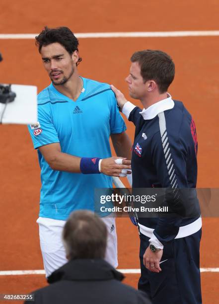 Fabio Fognini of Italy is congratulated by British team captain Leon Smith after his four set victory against James Ward of Great Britain during day...