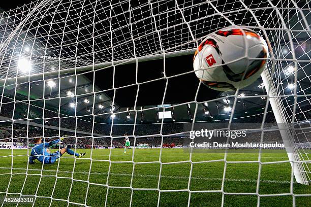 Max Kruse of VfL Wolfsburg takes and scores his penalty in the shoot out past Manuel Neuer of Bayern Muenchen during the DFL Supercup match between...