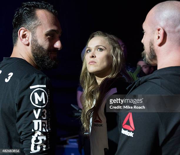 Edmond Tarverdyan, UFC women's bantamweight champion Ronda Rousey of the United States and Mike Dolce wait backstage during the UFC 190 weigh-in...
