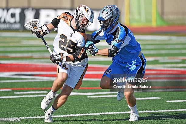 Kyle Denhoff of the Rochester Rattlers protects the ball in the fourth quarter as Jake Bernhardt of the Ohio Machine defends on August 1, 2015 at...