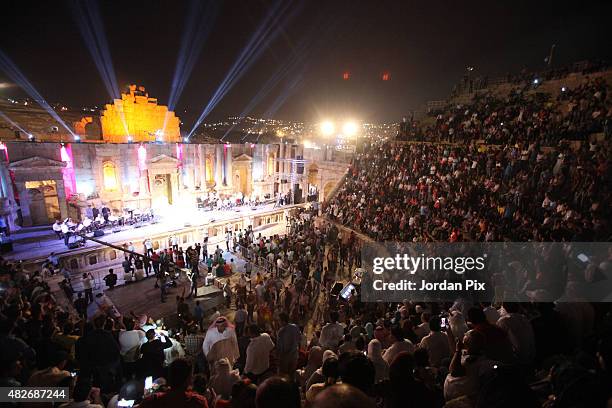 Fans who are mainly Kuwaitis and of other Arab Gulf states react to Kuwaiti singer Abdullah Rowaished as he performs Arabic songs at the main...