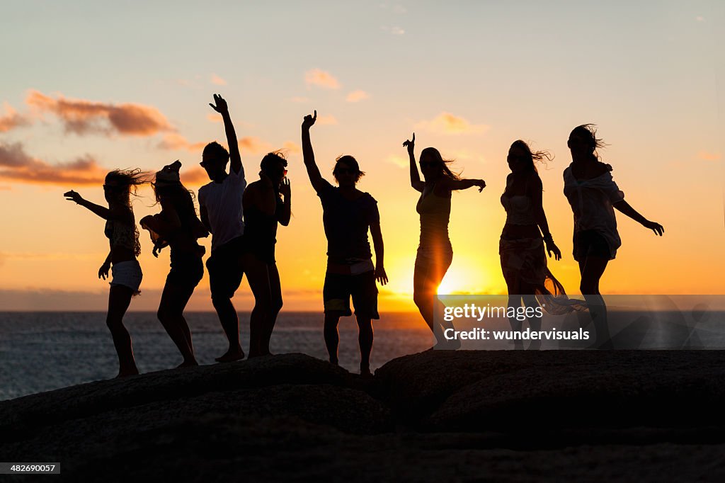 Young Party People Dancing On A Rock
