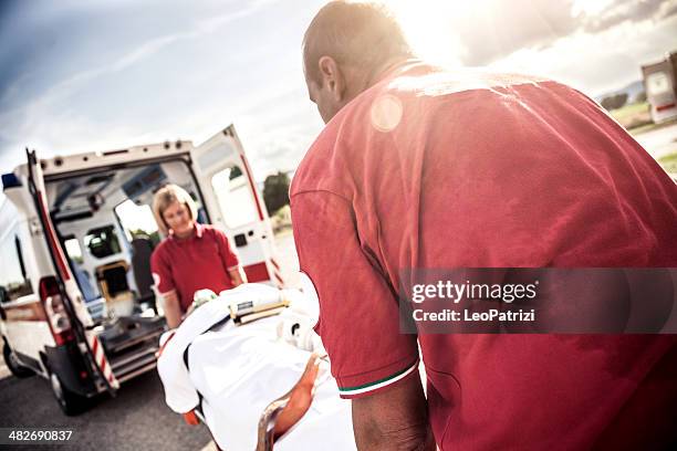 emt team provide first aid on the street - injured street stockfoto's en -beelden