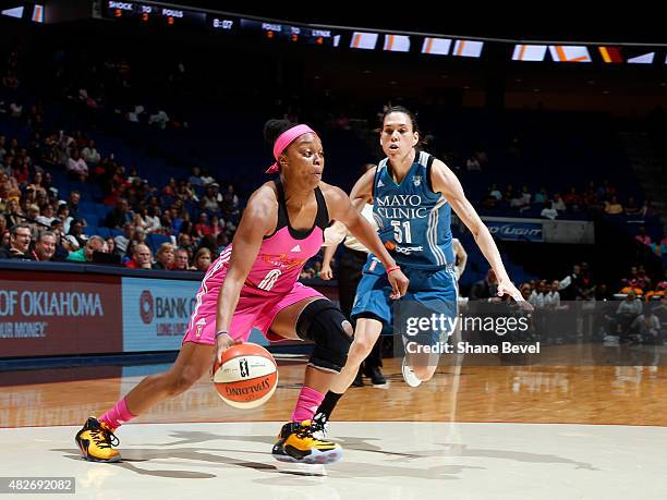 Odyssey Sims of the Tulsa Shock drives to the basket against Anna Cruz of the Minnesota Lynx on August 1, 2015 at the BOK Center in Tulsa, Oklahoma....