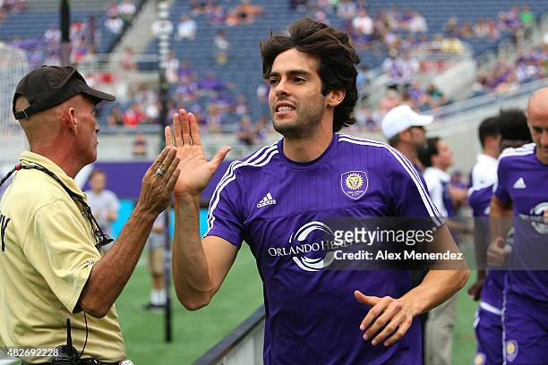 Kaka of Orlando City SC high fives a security member as he runs onto the pitch prior to a MLS soccer match between the Columbus Crew SC and the...