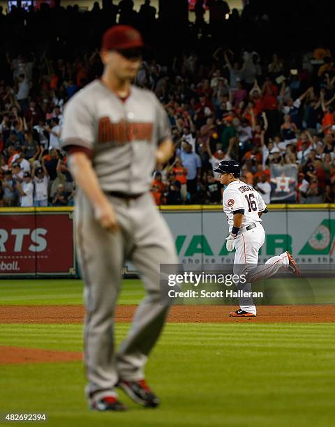 Hank Conger of the Houston Astros rounds the bases after hitting a grand slam in the fourth inning off Jeremy Hellickson of the Arizona Diamondbacks...