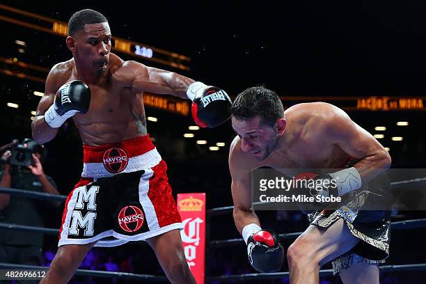 Danny Jacobs exchanges punches with Sergio Mora during their middleweight bout at Barclays Center on August 1, 2015 in Brooklyn borough of New York...