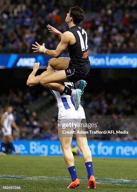 Blaine Boekhorst of the Blues marks the ball over Nick Dal Santo of the Kangaroos during the 2015 AFL round 18 match between the Carlton Blues and...