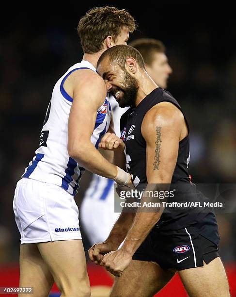 Kayne Turner of the Kangaroos remonstrates with Chris Yarran of the Blues during the 2015 AFL round 18 match between the Carlton Blues and the North...