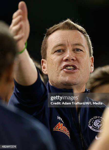 Interim Coach of the Blues John Barker addresses his players during the 2015 AFL round 18 match between the Carlton Blues and the North Melbourne...