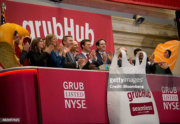 Matt Maloney, co-founder and chief executive of GrubHub Inc., center, gets ready to ring the opening bell on the floor of the New York Stock Exchange...