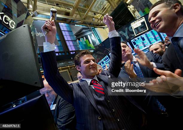 Matt Maloney, co-founder and chief executive of GrubHub Inc., center, reacts after the initial public offering listing on the floor of the New York...