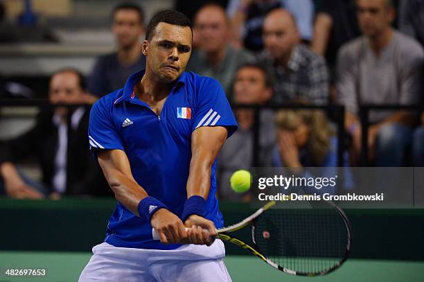 Jo-Wilfried Tsonga of France plays a backhand in his match against Peter Gojowzyk of Germany during day 1 of the Davis Cup Quarter Final match...