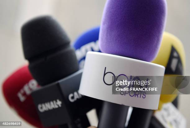 Photo taken on April 4, 2014 in Paris shows microphones of French television channel Canal + and Qatari station BeIn Sports. The French Ligue de...