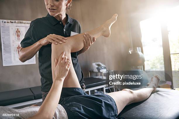 help for hurting muscles - massage therapist woman stock pictures, royalty-free photos & images