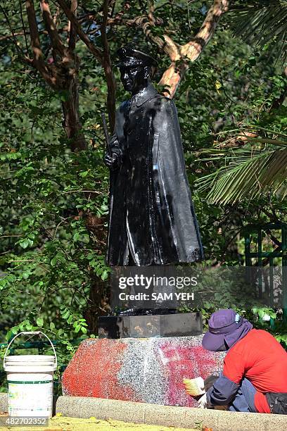 To go with AFP story TAIWAN-CHINA-POLITICS-CHIANG, FEATURE by Sam Yeh This picture taken on August 27, 2014 shows a worker cleaning paint off the...