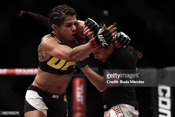 Claudia Gadelha of Brazil punches Jessica Aguilar of the United States in their strawweight bout during the UFC 190 Rousey v Correia at HSBC Arena on...