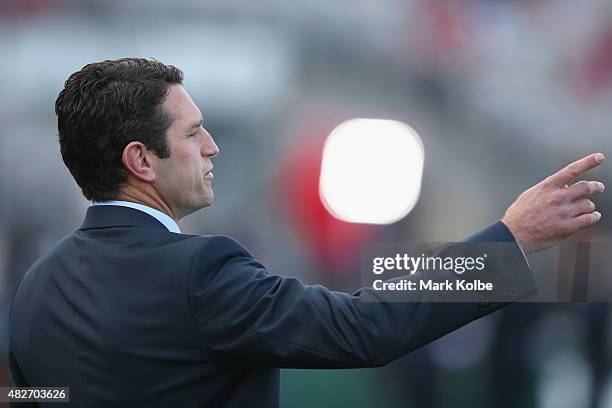 Knights coach Danny Buderus calls instructions as he watches on during his team's warm-upbefore the round 21 NRL match between the St George...