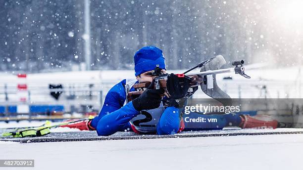 young man shooting at biathlon training - winter sports competition stock pictures, royalty-free photos & images