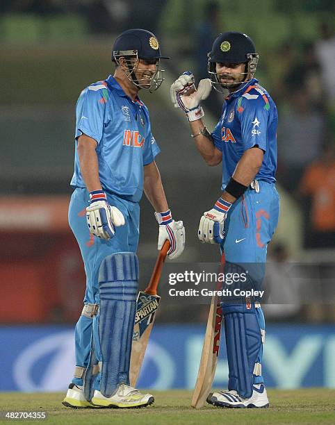 Virat Kohli and Mahendra Singh Dhoni of India share a joke during the ICC World Twenty20 Bangladesh 2014 semi final between India and South Africa at...
