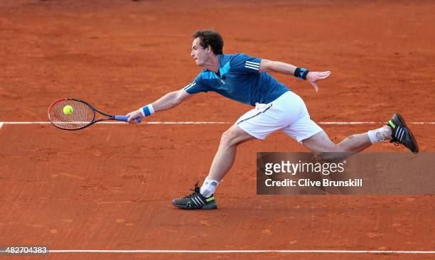 Andy Murray of Great Britain stretches to play a forehand volley against Andreas Seppi of Italy during day one of the Davis Cup World Group Quarter...